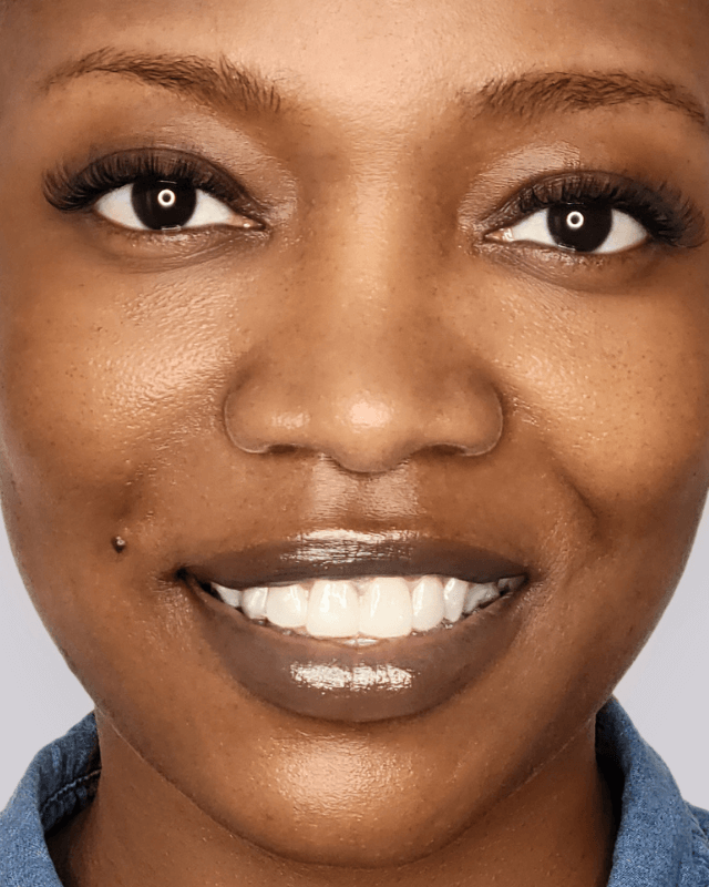 beautiful dark woman smiling with eyelash extensions